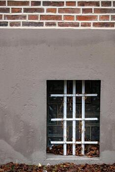 barred cellar window in an old building photo
