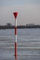 the river rhine in germany at high water with red and white markings photo