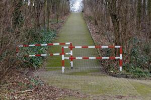 red and white metal barrier on path photo