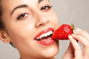 Sexy Woman Eating Strawberry photo