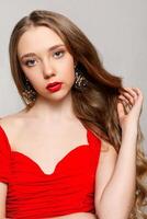 Beautiful model brunette with long curled hair photo