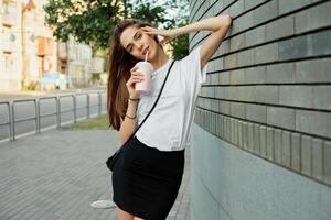 Portrait of a young brunette woman in a white T-shirt photo