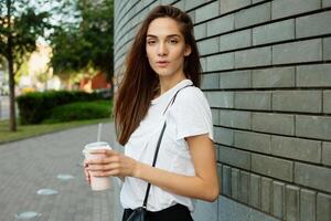 Portrait of a young brunette woman in a white T-shirt photo