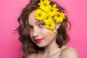 A beautiful young girl, on a pink background photo