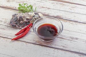 Chinese cuisine - oyster sauce served shell photo