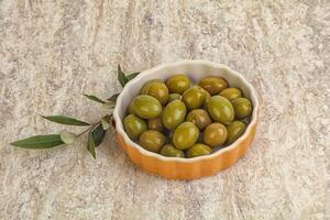 Tasty marinated olives in the bowl photo