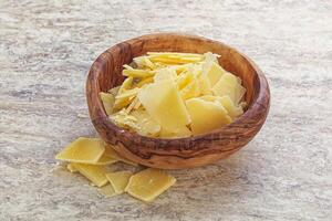 Sliced parmesan cheese heap in the bowl photo