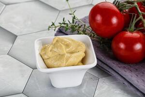 Dijon mustard sauce in the bowl photo