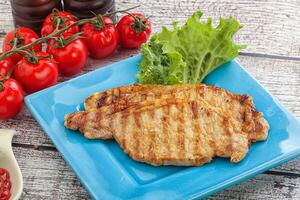 Grilled pork steak with ketchup photo