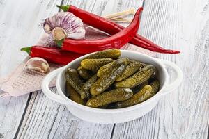 Marinated small cucumbers in the bowl photo