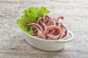 Marinated squid tentacles in the bowl photo