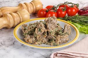 Fried turkey liver with herbs in cream sauce photo