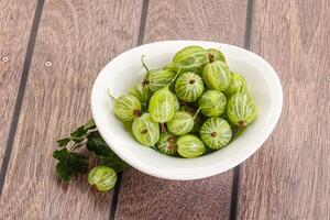 Sweet ripe gooseberries in the bowl photo