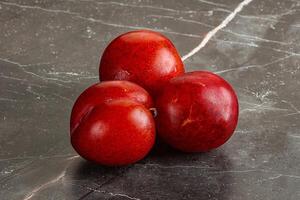 Ripe sweet juicy red plum photo