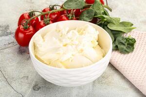 Soft cream cheese in the bowl photo