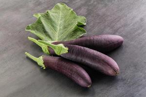 Raw ripe organic eggplant with leaf photo