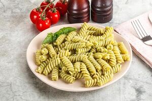 Italian pasta with basil pesto photo