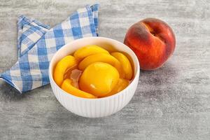 Ripe sweet and juicy canned peach photo