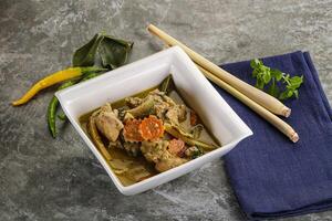 Thai green curry soup with basil photo