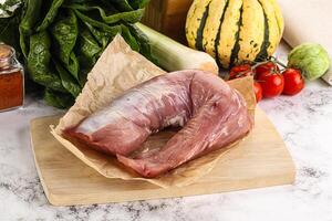 Uncooked raw pork tenderloin with spices photo