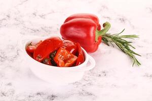 Pickled red bell pepper in the bowl photo