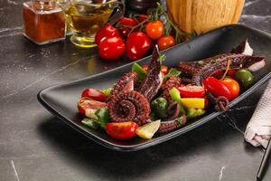 Salad with octopus tentacle and vegetables photo