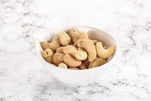 Cashew nuts heap in the bowl photo
