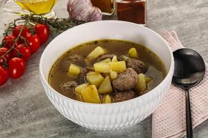 Soup with meatball and potato photo