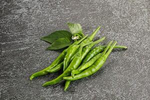 Spicy green chili pepper heap photo