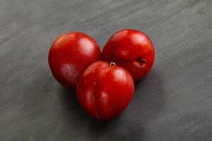 Ripe sweet juicy red plum photo