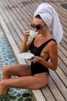 Pretty woman enjoying her morning coffee. photo