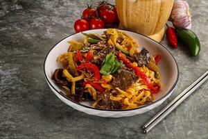 Asian wok with noodle, vegetables and beef photo