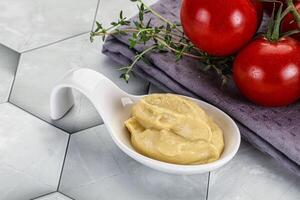 Dijon mustard sauce in the bowl photo