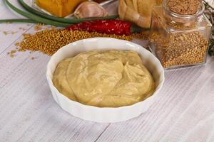 Dijon mustard sauce in the bowl photo