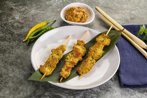 Thai meat skewer Satay with sauce photo