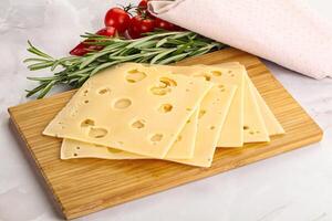 Sliced maasdam cheese with holes photo