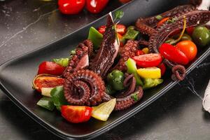 Salad with octopus tentacle and vegetables photo