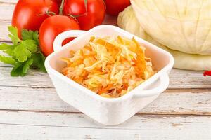 Fermented cabbage sauerkraut in the bowl photo