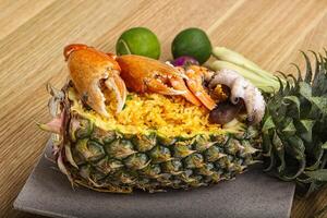 Rice with seafood in pineapple photo