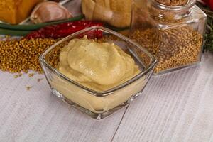 Dijon mustard sauce in the bowl photo