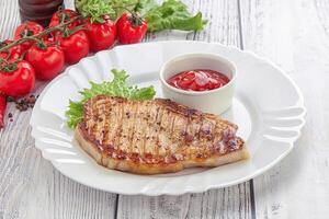 Grilled pork steak with ketchup photo