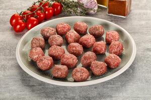 Uncooked raw beef meatball minced photo