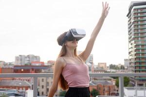 amazed young beautiful girl using new VR technology photo