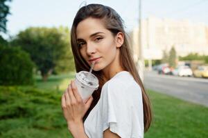 Portrait of a young brunette woman in a white T-shirt photo