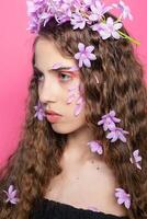 Beautiful girl with flowers in in hair photo