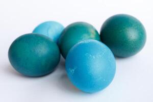 Row of ombre blue Easter eggs isolated on white background photo