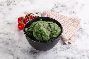Green spinach leaves in the bowl photo