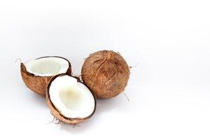 Ripe coconuts and half coconut on white background photo