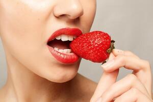 Sexy Woman Eating Strawberry photo