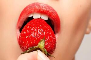 Sexy Woman Eating Strawberry photo